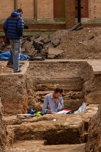 An archeologist working in a trench